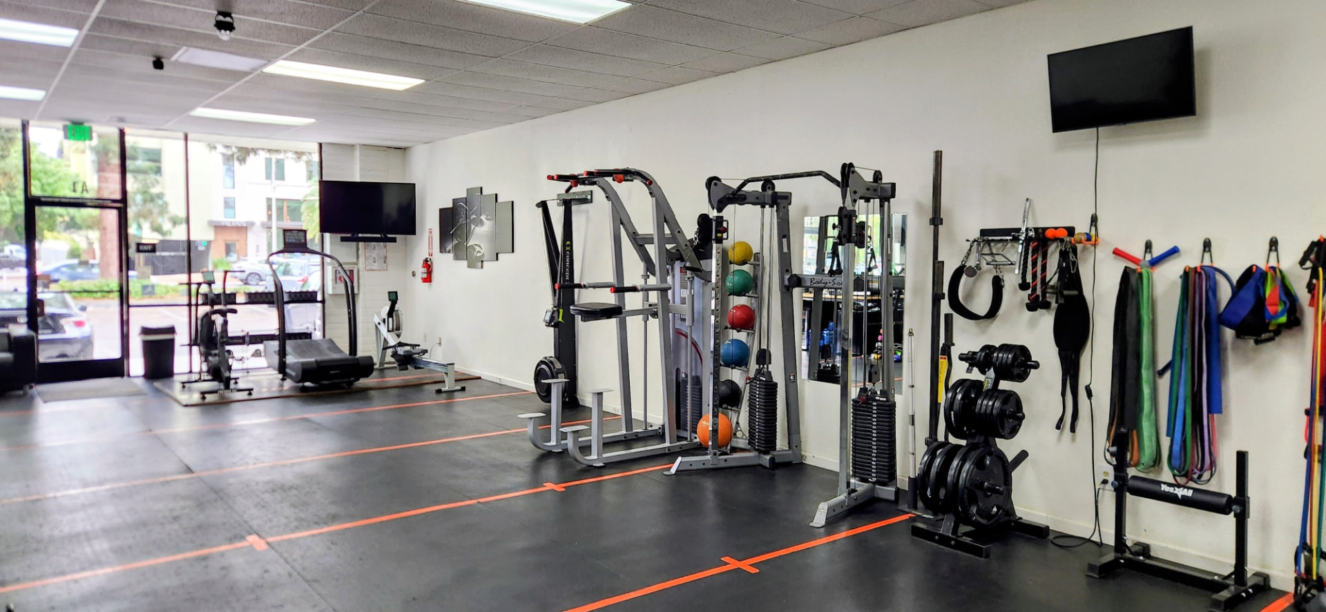 Power rack, medicine balls and resistance bands at Helios Fit