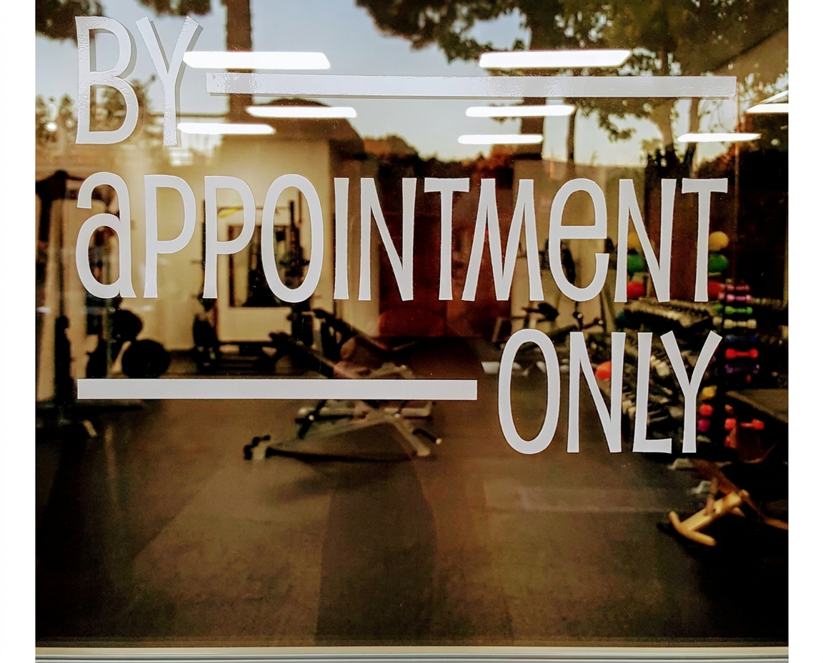 By appointment only lettering on the Helios Fit glass door